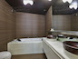 The master bathroom has a Jacuzzi tub, two sinks and a built-in mirror. It is one of four bathrooms in the house